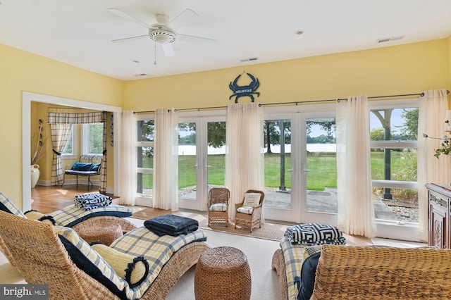 sunroom / solarium featuring ceiling fan and french doors