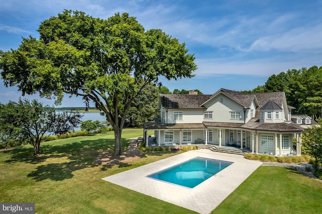 back of house featuring a lawn and a patio