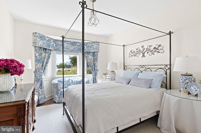 bedroom featuring hardwood / wood-style floors and an inviting chandelier