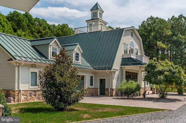 view of front of house featuring a balcony