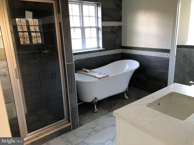 bathroom featuring tile walls, tile floors, separate shower and tub, and vanity