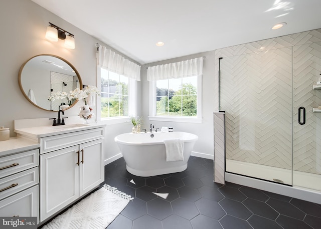 bathroom with tile flooring, plus walk in shower, and vanity with extensive cabinet space