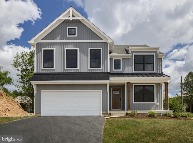 view of front facade featuring a front lawn, a porch, and a garage