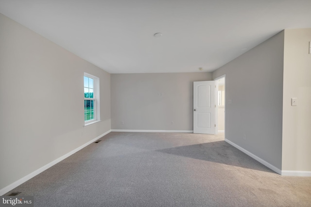 unfurnished room with light colored carpet