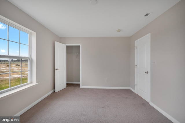 unfurnished bedroom featuring light carpet