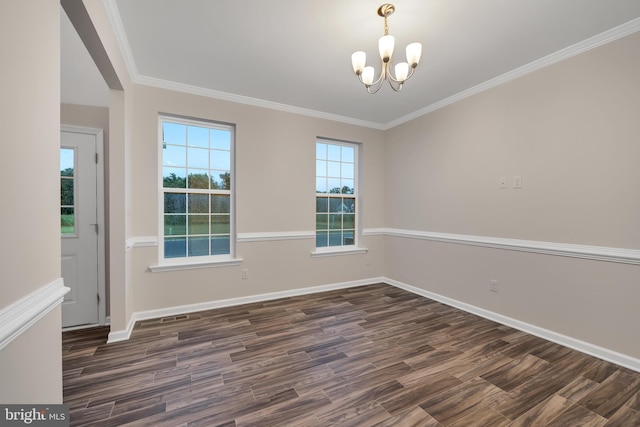 unfurnished dining area featuring ornamental molding, dark wood-type flooring, and an inviting chandelier