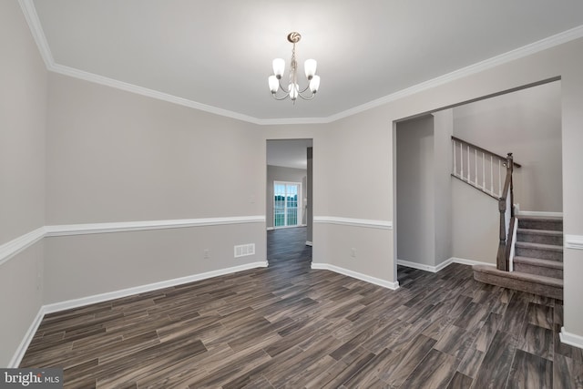 empty room with dark hardwood / wood-style flooring, a notable chandelier, and ornamental molding