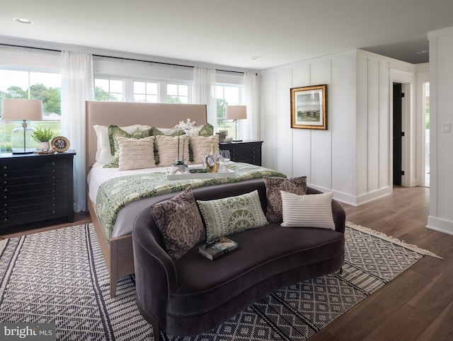 bedroom with multiple windows and hardwood / wood-style floors