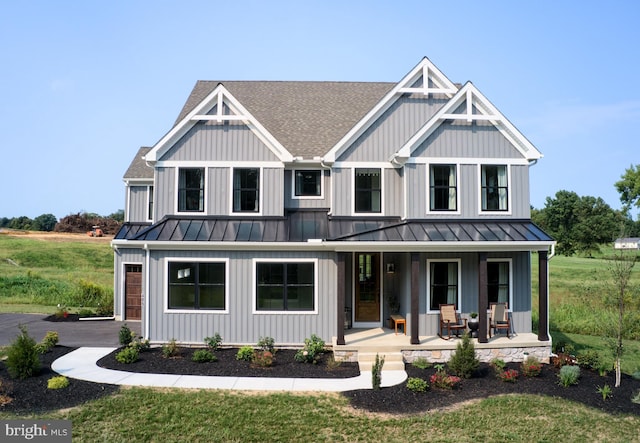 view of front of house with a porch and a front yard