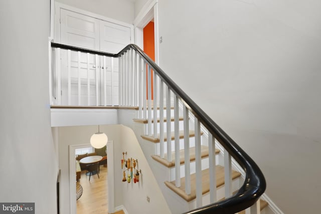 stairs with light hardwood / wood-style floors