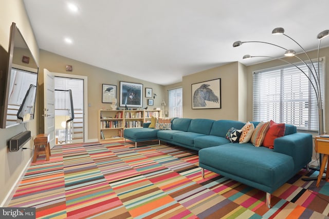 carpeted living room featuring vaulted ceiling