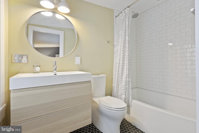 full bathroom featuring shower / bath combo with shower curtain, tile floors, toilet, and vanity with extensive cabinet space