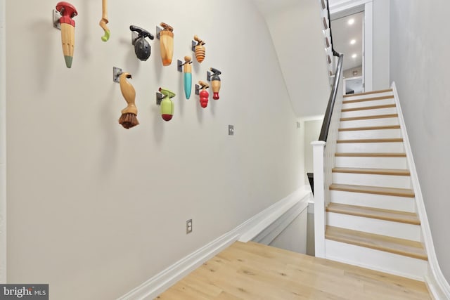 staircase with light hardwood / wood-style flooring