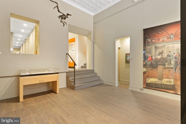 interior space with crown molding and light wood-type flooring