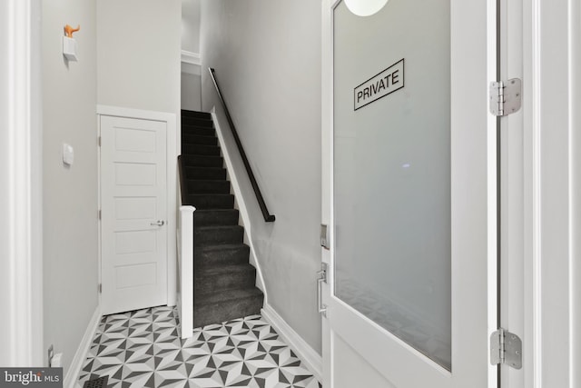 stairs featuring light tile flooring