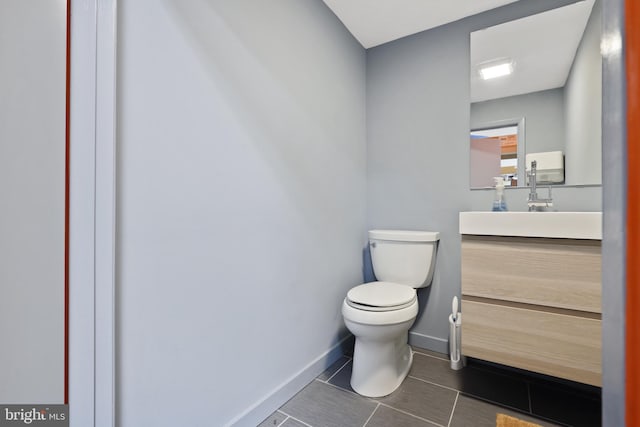 bathroom featuring vanity, toilet, and tile floors