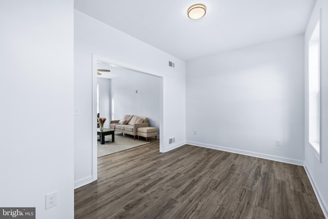 empty room with dark hardwood / wood-style flooring