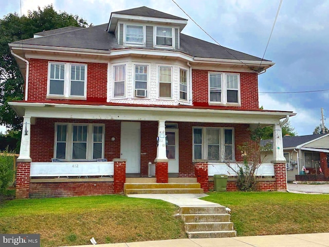 view of front of property with a front lawn and a porch