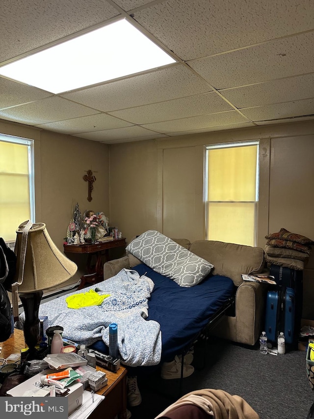 carpeted bedroom featuring a paneled ceiling