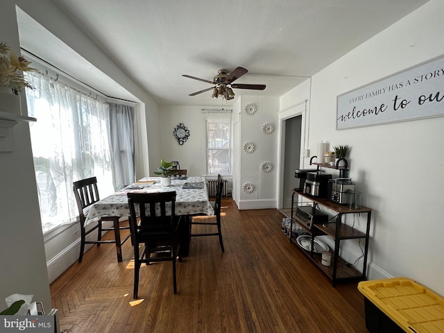 dining space featuring ceiling fan, dark parquet floors, and a wealth of natural light