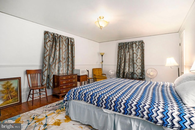 bedroom featuring crown molding and dark wood-type flooring