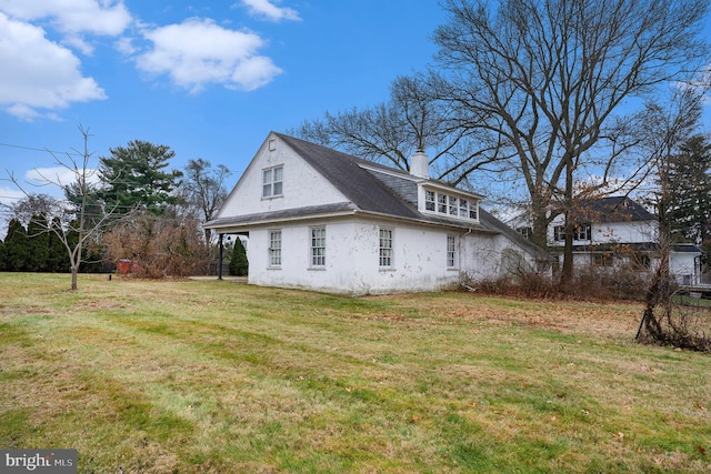 view of home's exterior with a lawn