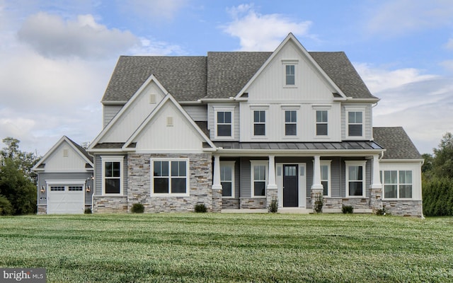 craftsman-style home featuring a garage, covered porch, and a front lawn