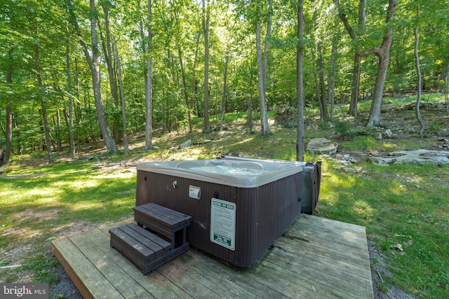 wooden deck with a hot tub