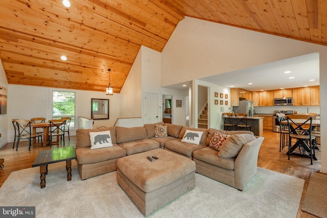 living room with high vaulted ceiling, wooden ceiling, and light hardwood / wood-style flooring