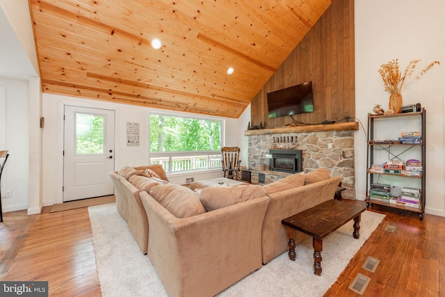 living room with high vaulted ceiling, light wood-type flooring, a fireplace, and wood ceiling