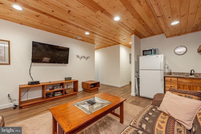 living room featuring light hardwood / wood-style flooring, sink, and wood ceiling