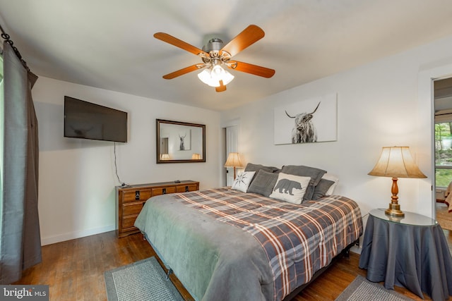 bedroom featuring ceiling fan and dark wood-type flooring