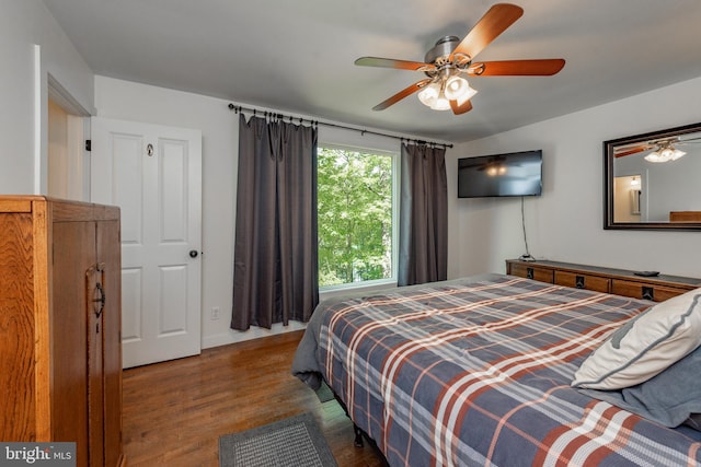 bedroom with ceiling fan and dark hardwood / wood-style floors