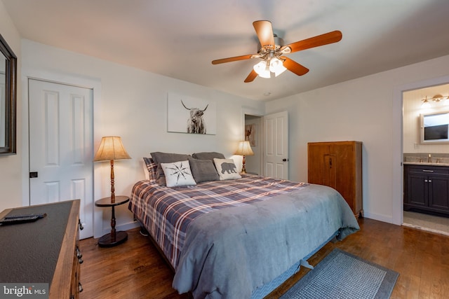 bedroom with connected bathroom, dark hardwood / wood-style floors, ceiling fan, and sink