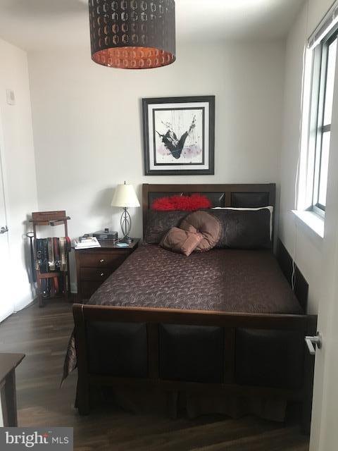 bedroom featuring dark wood-type flooring