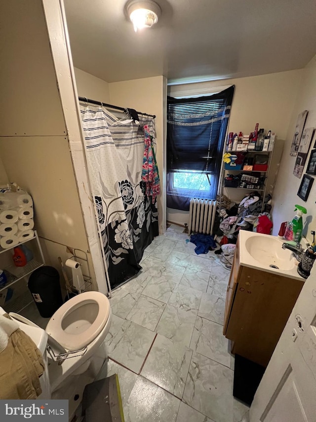 bathroom featuring tile flooring, toilet, vanity, and radiator