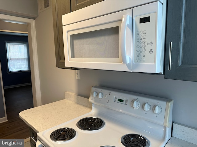 kitchen with dark hardwood / wood-style flooring and range