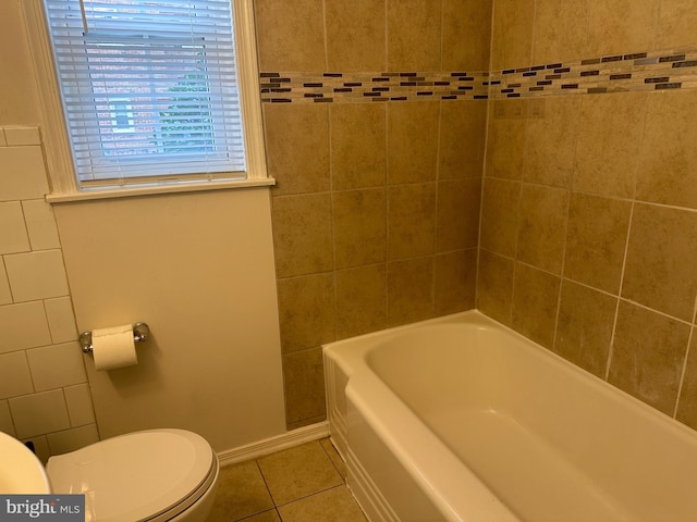 bathroom featuring tile flooring and toilet