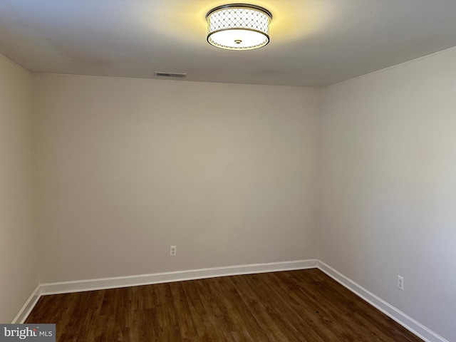 empty room with dark hardwood / wood-style floors