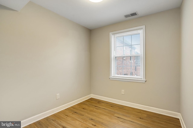 empty room with light hardwood / wood-style flooring