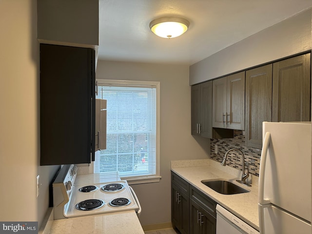 kitchen with white appliances, dark brown cabinets, tasteful backsplash, and sink