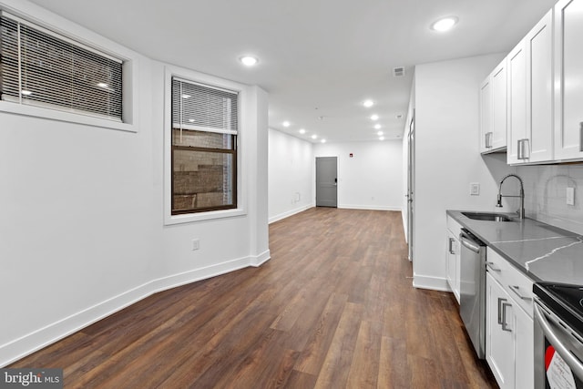 kitchen featuring backsplash, dark wood-type flooring, white cabinets, dishwasher, and sink