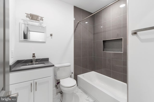 full bathroom featuring tiled shower / bath combo, vanity, tile flooring, and toilet