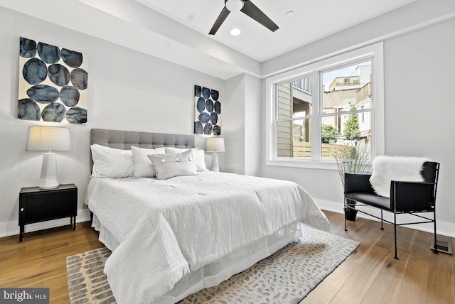 bedroom with light hardwood / wood-style floors and ceiling fan