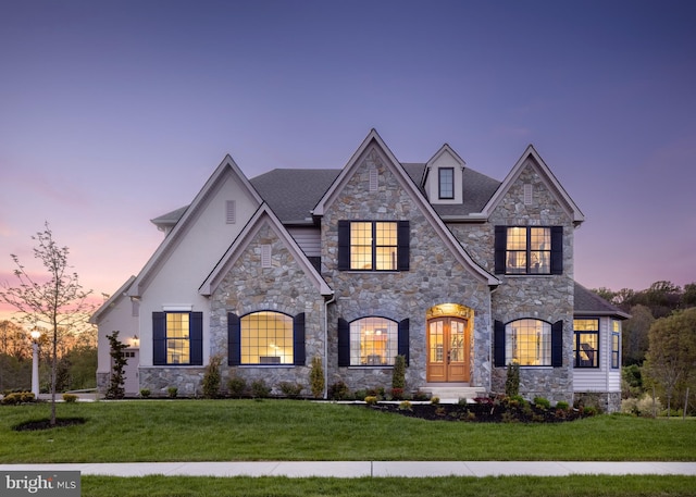 french country style house with french doors and a front lawn