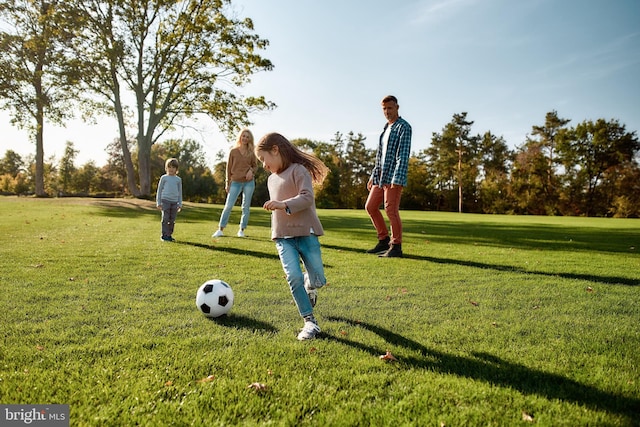 view of property's community with a lawn