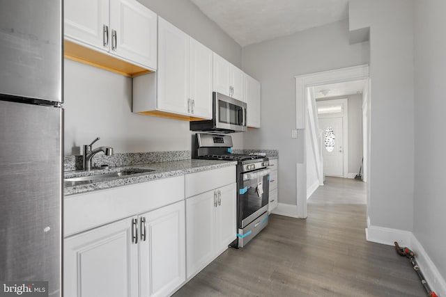 kitchen featuring white cabinets, dark hardwood / wood-style floors, sink, and stainless steel appliances