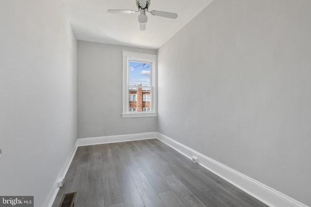 spare room featuring dark hardwood / wood-style flooring and ceiling fan