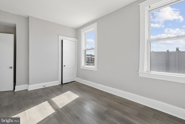 spare room featuring dark hardwood / wood-style flooring