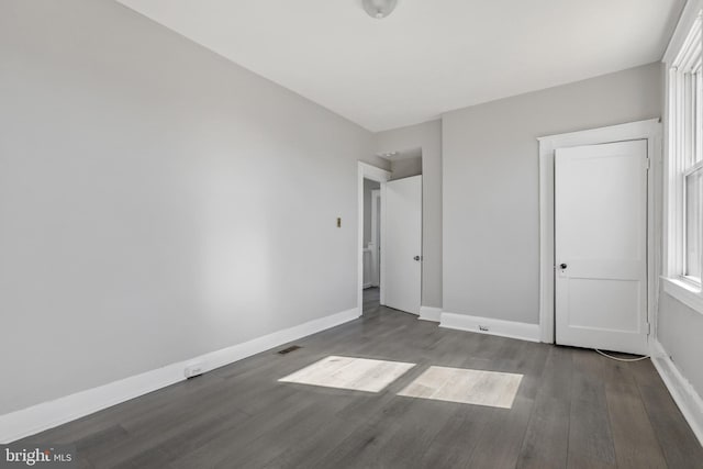 unfurnished room featuring dark hardwood / wood-style flooring